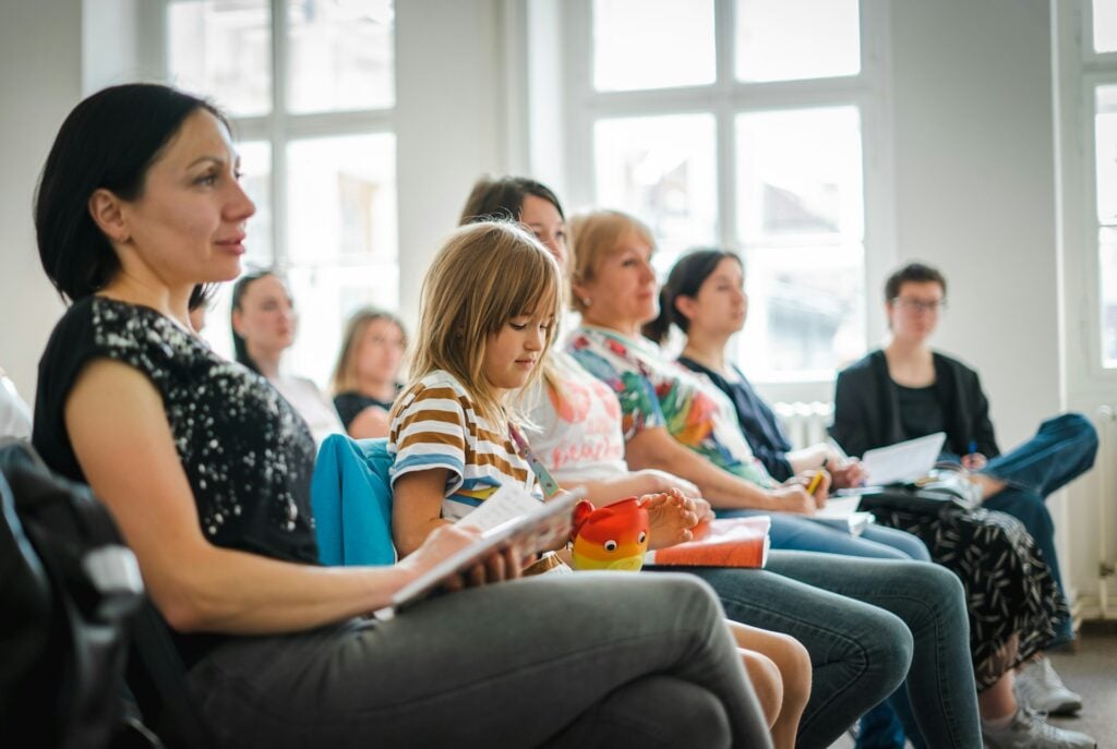 Parents and child at seminar